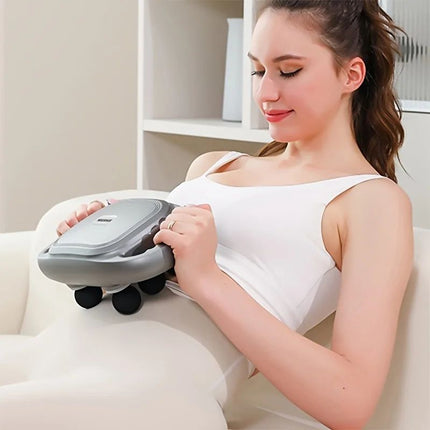 Woman using a handheld massager on her arm in a home setting