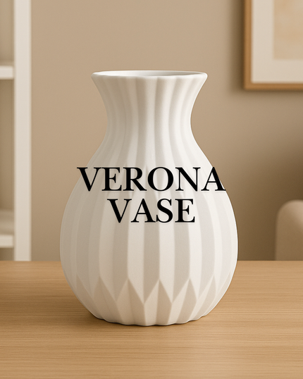 White vase with 'VERONA VASE' text on a wooden surface