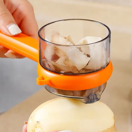 Orange and clear kitchen tool being used to extract juice from a lemon.